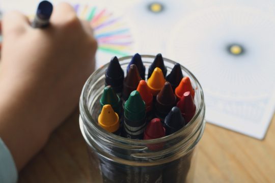 A picture of a jar of wax crayons